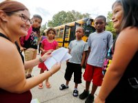 1009397793 ma nb HayMacFistDay  Julie Miller, left, helps students find which door to enter on their first day of school at the Hayden McFadden Elementary School in New Bedford.  PETER PEREIRA/THE STANDARD-TIMES/SCMG : education, school, students